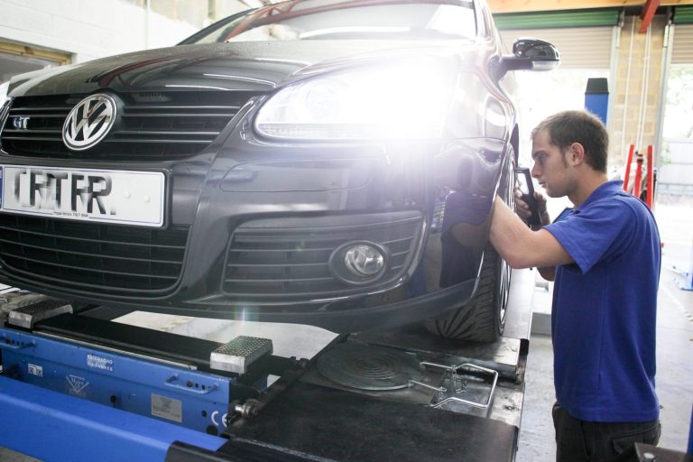 Our Services - Servicing Image of a technician working on the wheel of a car